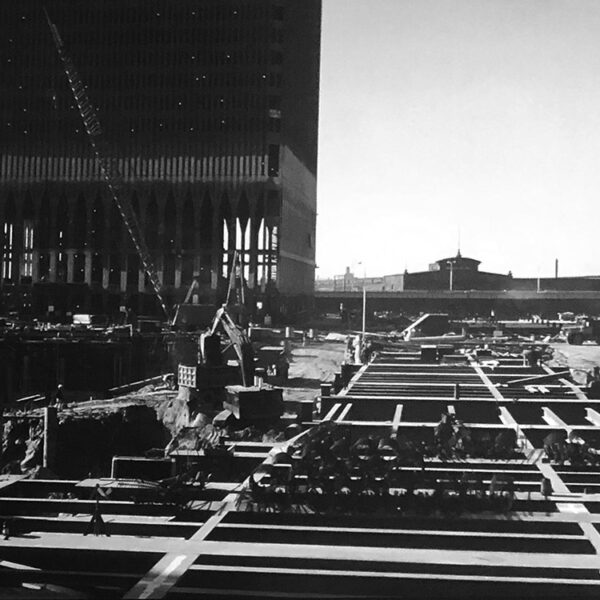 Photograph of the laying of floor plate steel beams at the World Trade Center block under construction.