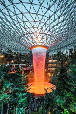 A waterfall that is part of a nature inspired building